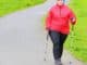 Übergewichtige Frau mit Nordic Walking Schuhen